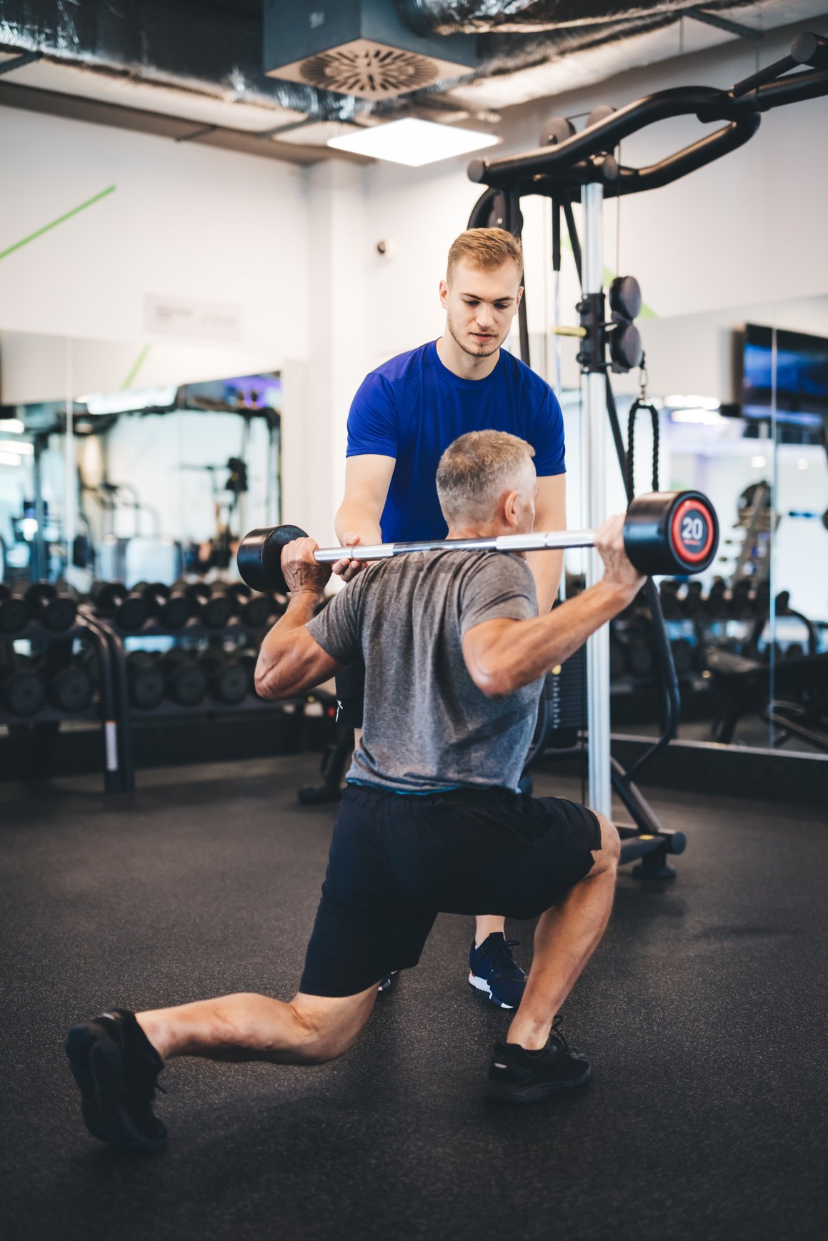 Senior Man Exercising with Personal Trainer.