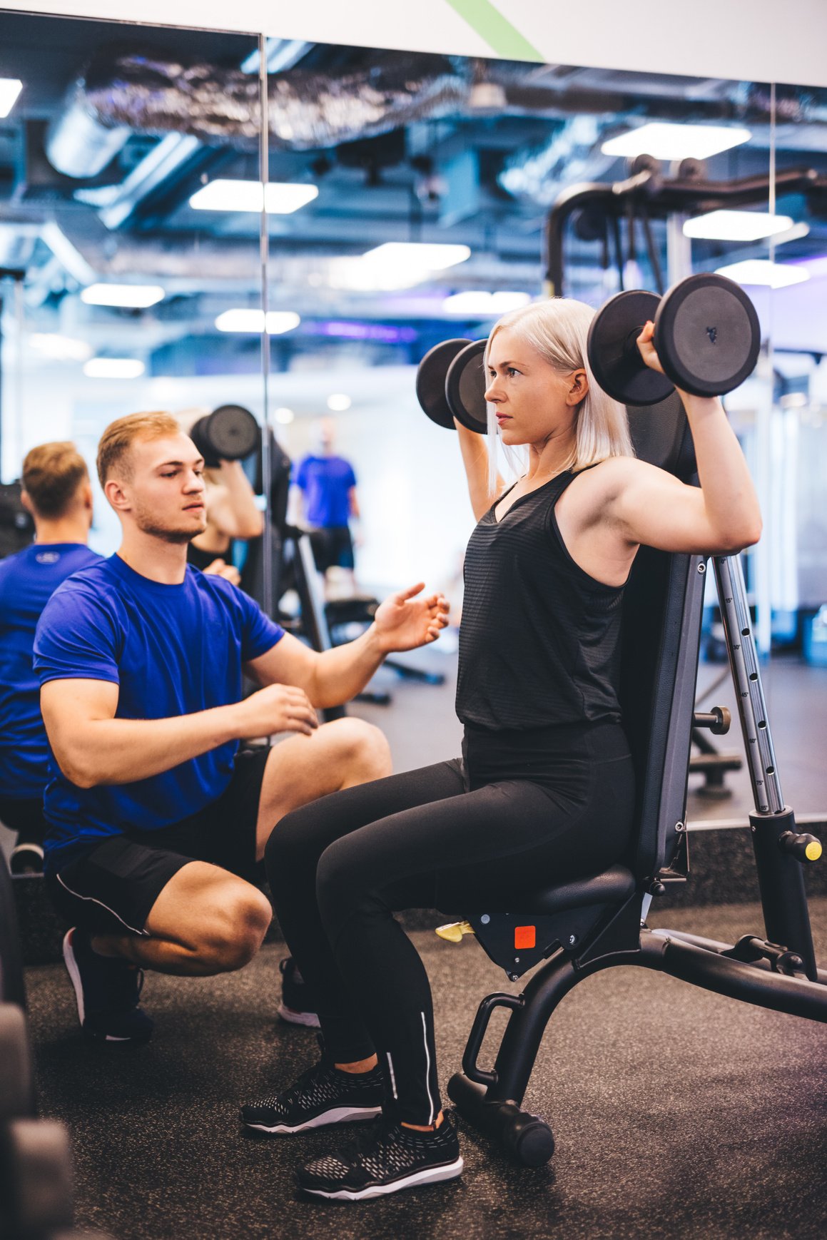 Woman Lifting Weights, Exercising with Personal Trainer.